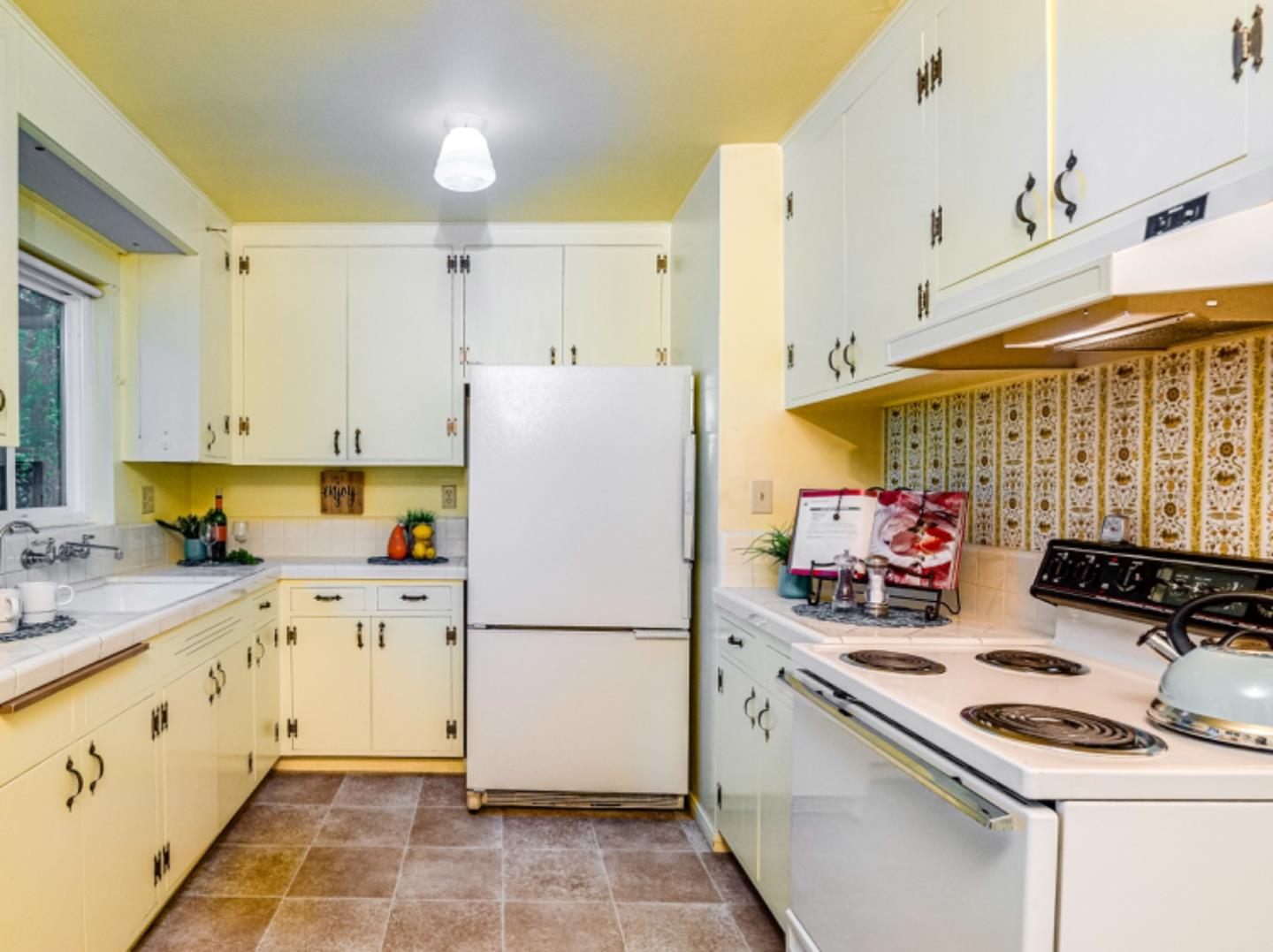 1122 Merrimac Drive Sunnyvale, CA 94087 - Photo 6 of 26 a kitchen with a refrigerator a stove a sink and white cabinets