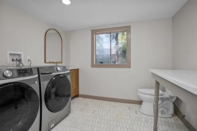 a view of a bathroom with washing machine and a sink
