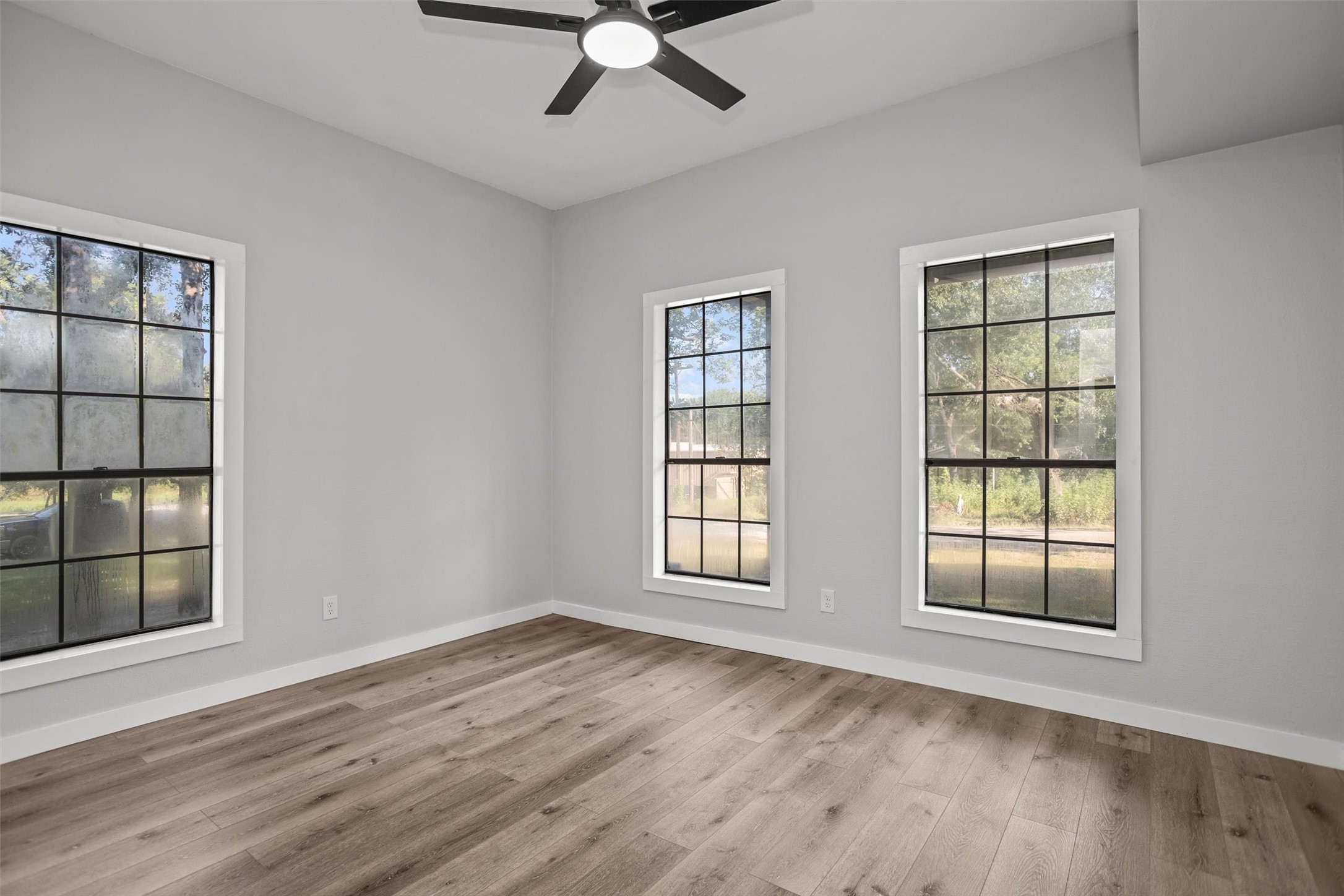 170 Noble Street Lovelady, TX 75851 - Photo 15 of 23 a view of an empty room with a window and wooden floor