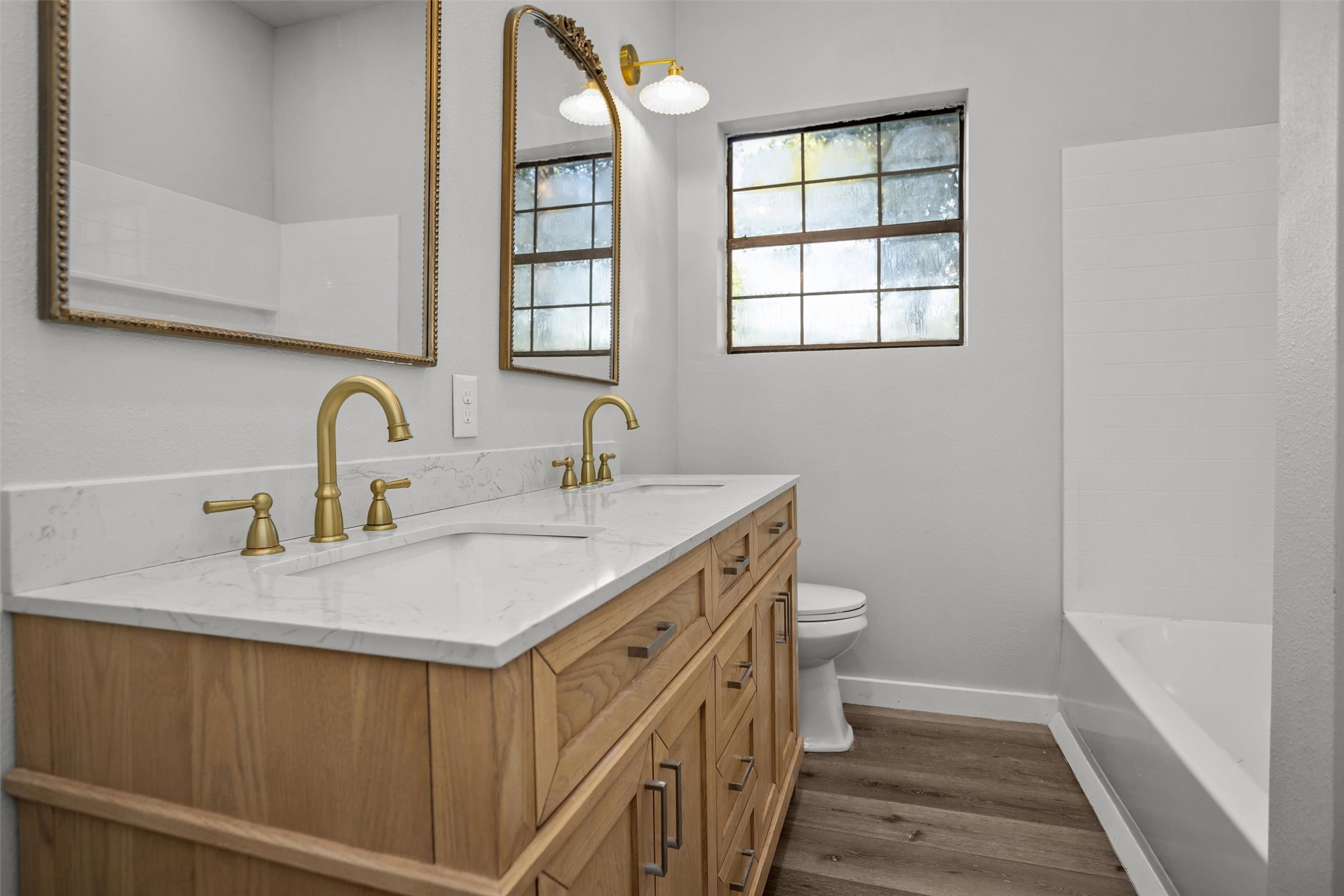 170 Noble Street Lovelady, TX 75851 - Photo 16 of 23 a bathroom with a double vanity sink toilet and a mirror