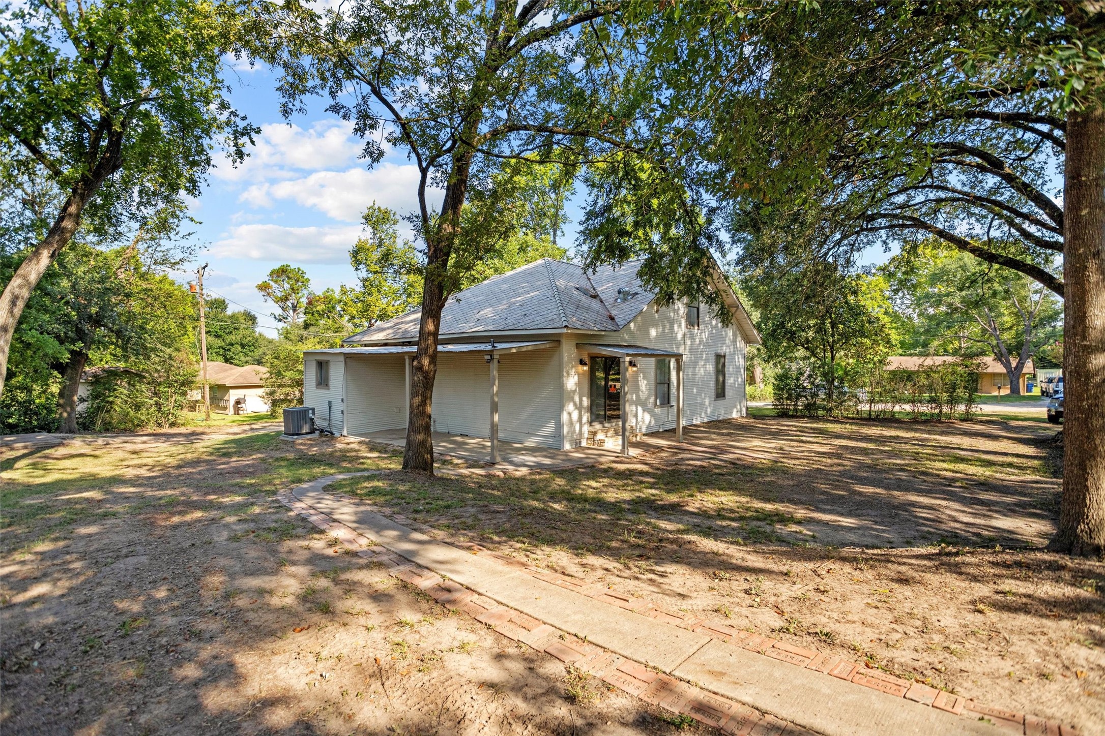 170 Noble Street Lovelady, TX 75851 - Photo 22 of 23 a front view of a house with a yard and garage