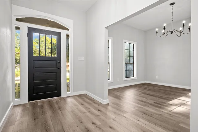 wooden floor in an empty room with a window