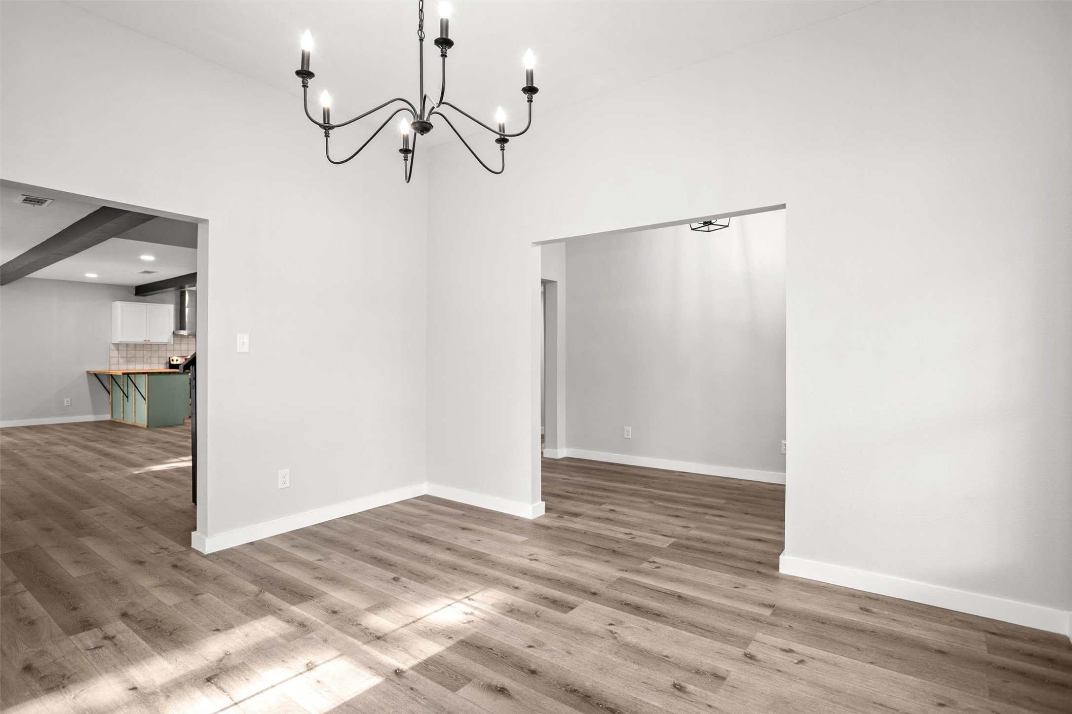 170 Noble Street Lovelady, TX 75851 - Photo 4 of 23 a view of an empty room with wooden floor and a window
