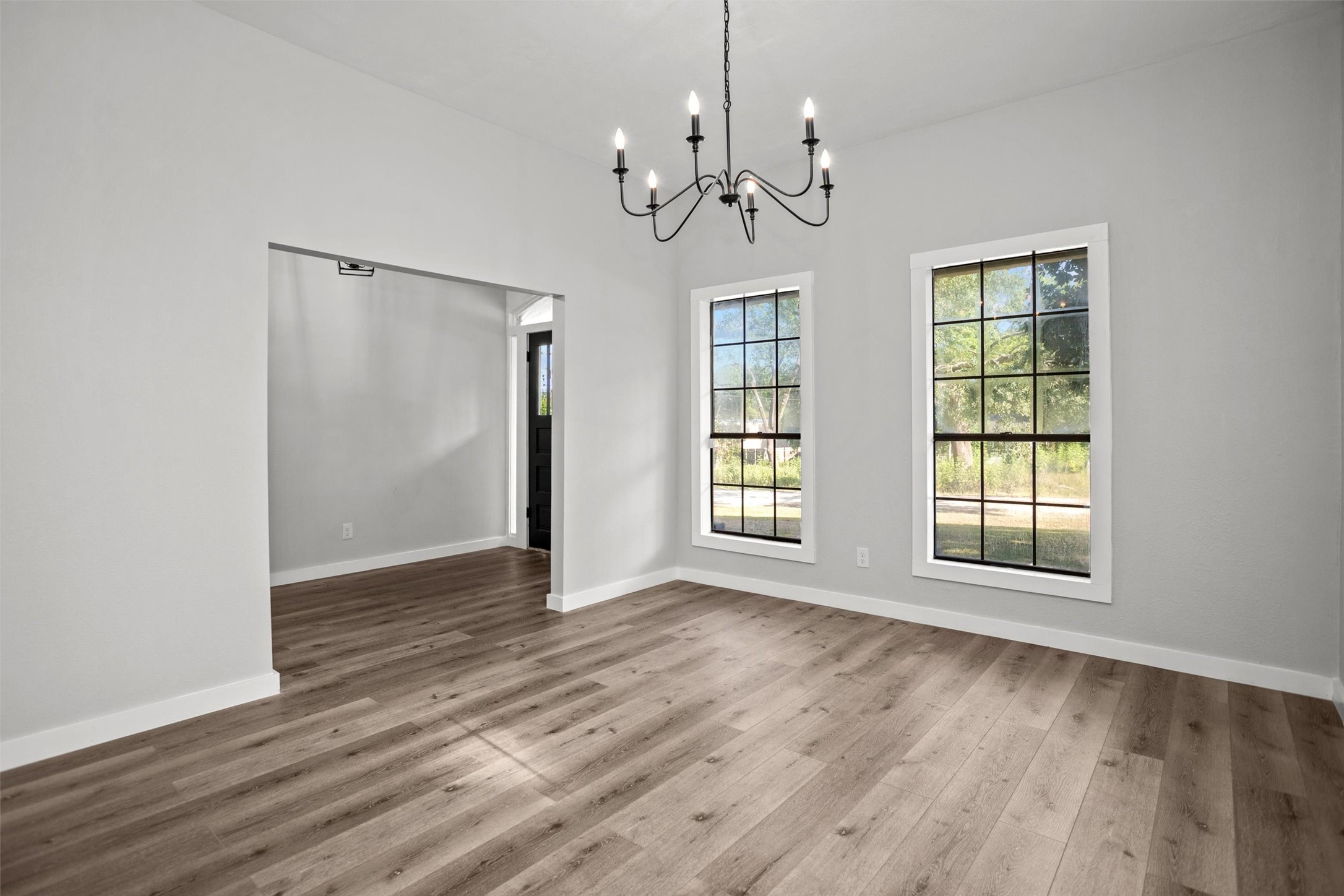 170 Noble Street Lovelady, TX 75851 - Photo 5 of 23 a view of an empty room with wooden floor and a window