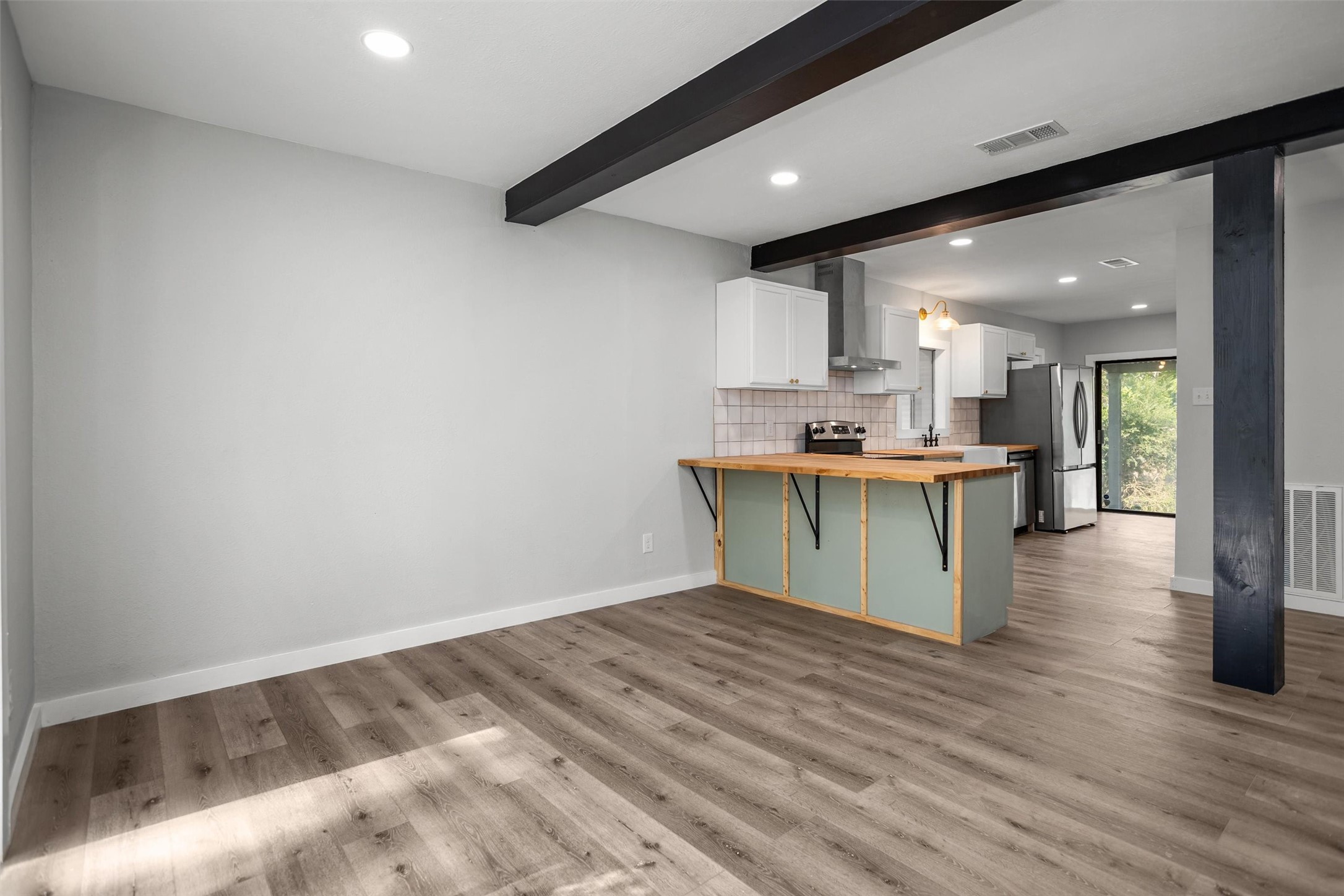 170 Noble Street Lovelady, TX 75851 - Photo 7 of 23 a room with kitchen island stainless steel appliances a sink and cabinets