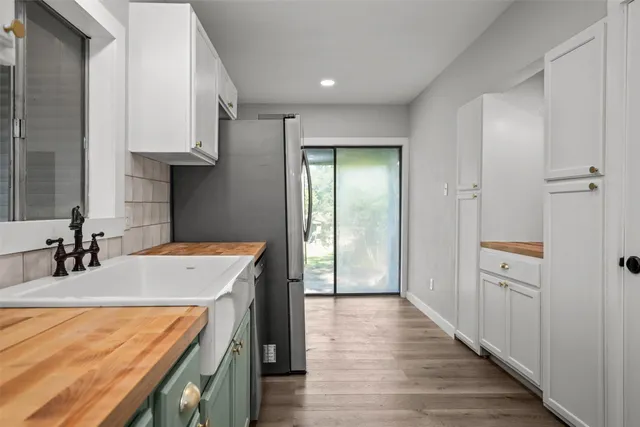 a kitchen with stainless steel appliances granite countertop a refrigerator and a sink