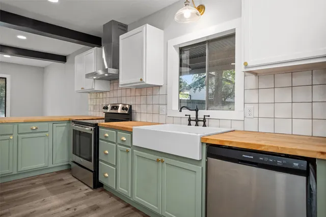 a kitchen with a sink stove and cabinets