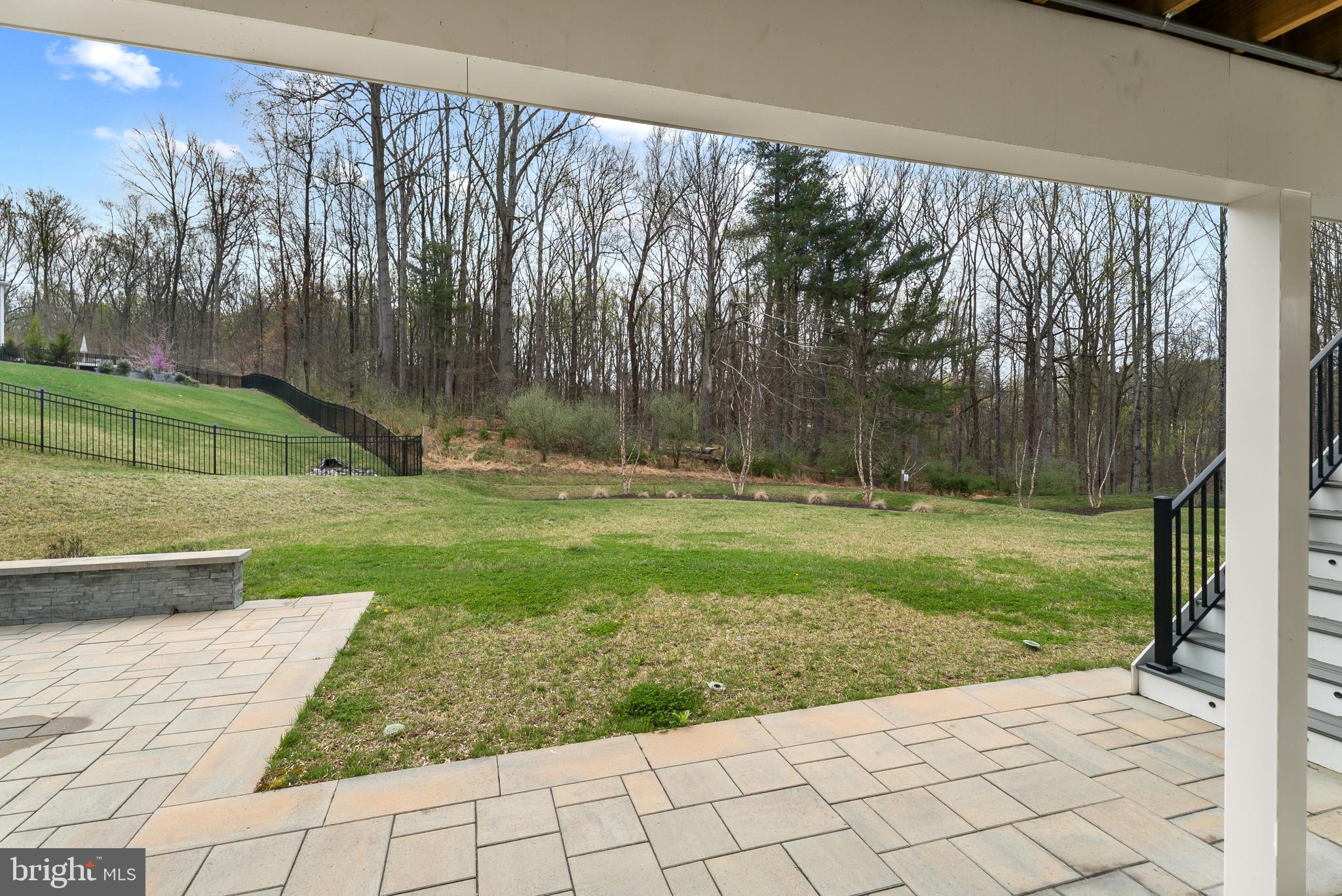 12444 Potomac Hunt Road North Potomac, MD 20878 - Photo 43 of 47 Serene backyard with lush greenery.