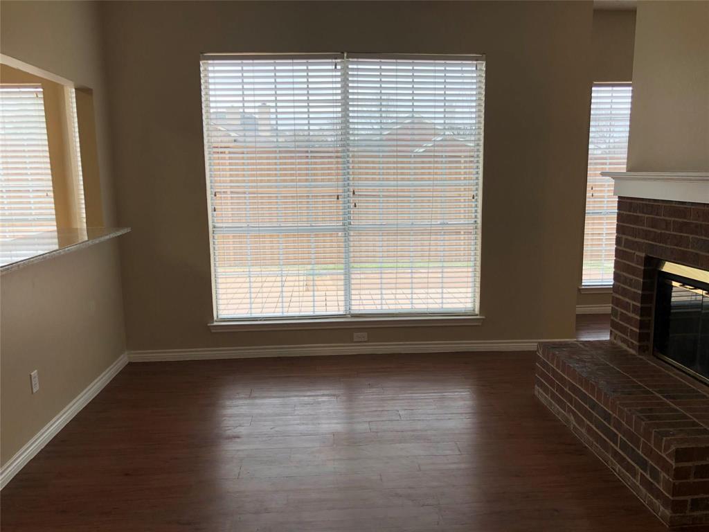 8301 Bells Street Frisco, TX 75035 - Photo 8 of 24 a view of an empty room with wooden floor and a window