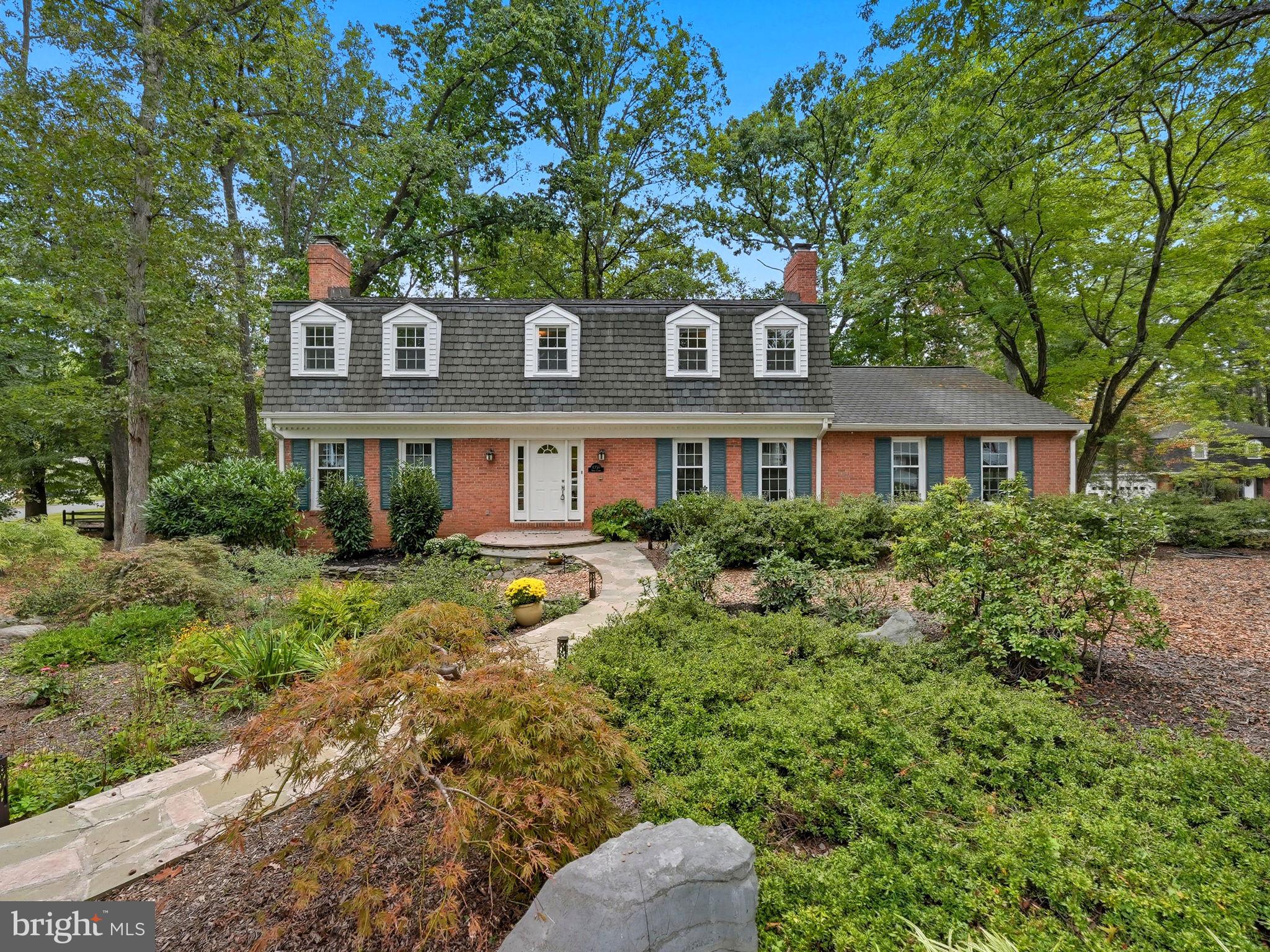 a front view of a house with yard and green space