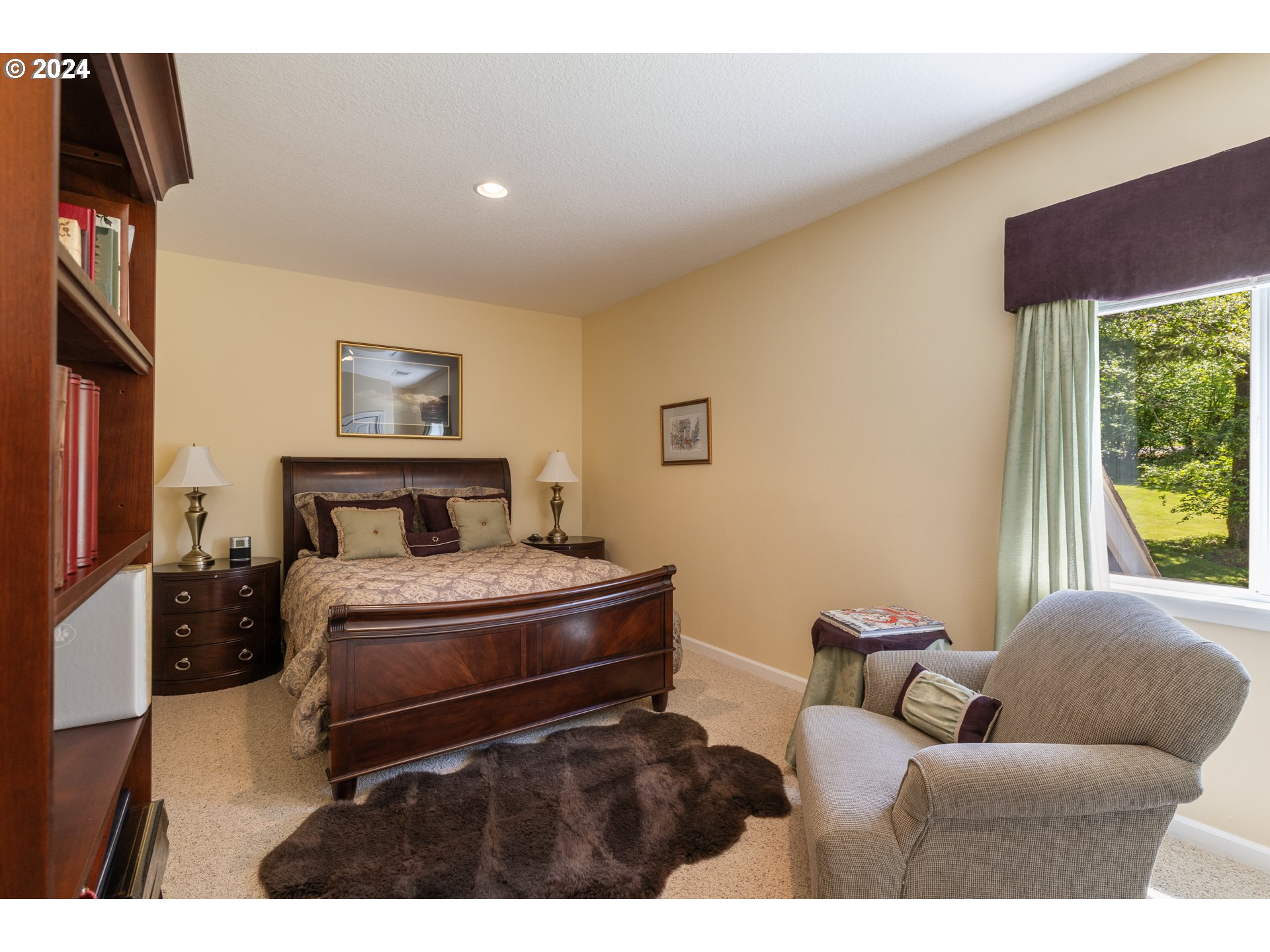19100 Southwest Finnigan Hill Road Newberg, OR 97132 - Photo 29 of 48 a bedroom with furniture and a fireplace
