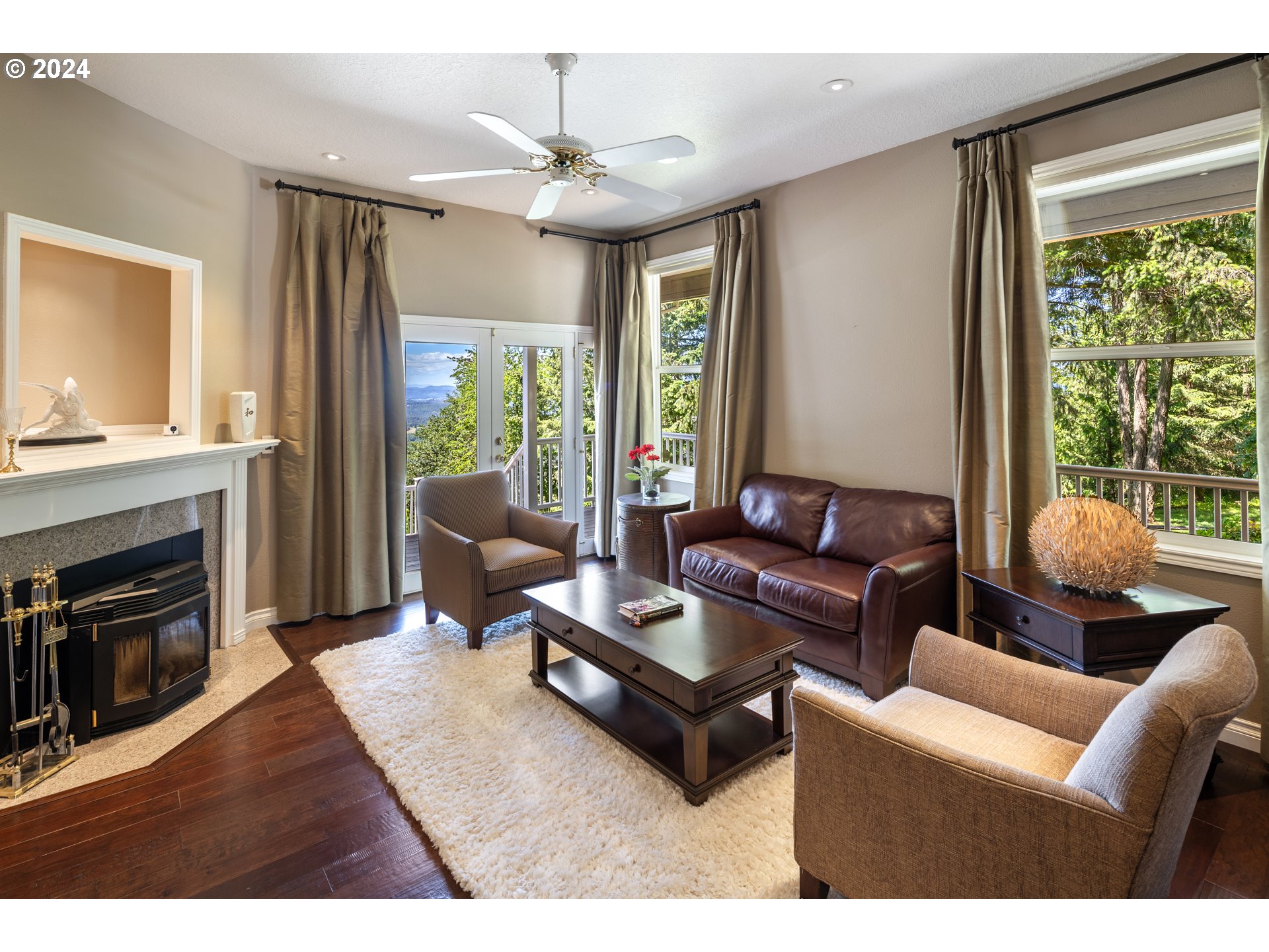 19100 Southwest Finnigan Hill Road Newberg, OR 97132 - Photo 7 of 48 a living room with furniture a fireplace and a large window