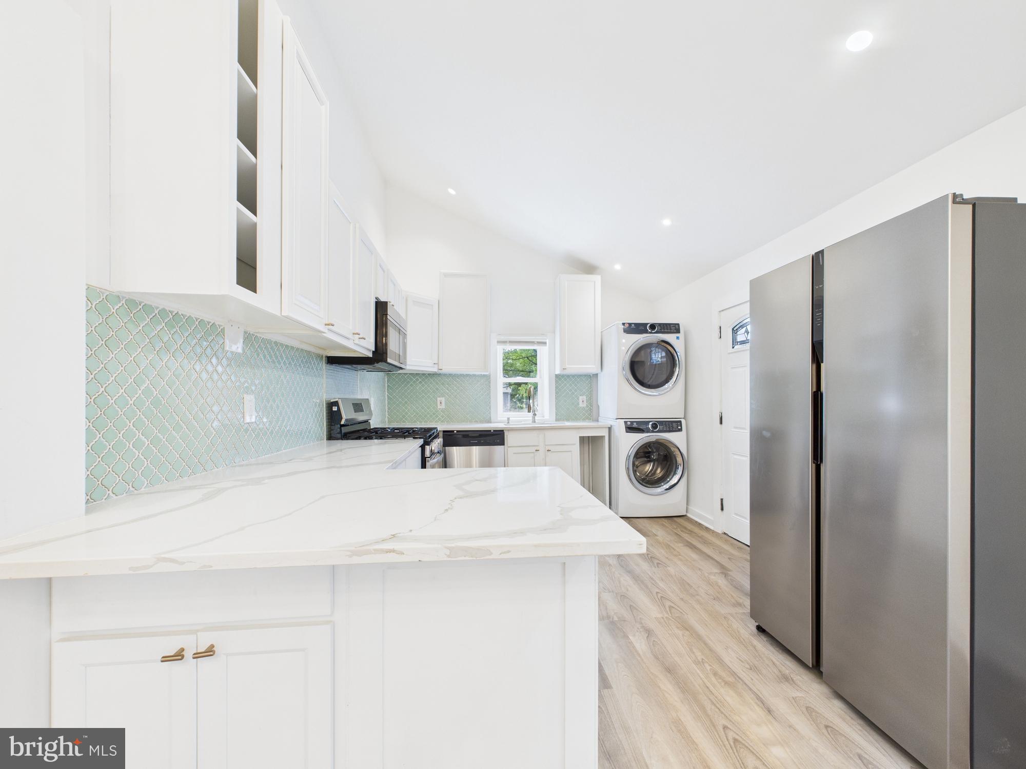 944 Balboa Avenue Capitol Heights, MD 20743 - Photo 13 of 49 a kitchen with stainless steel appliances a refrigerator a sink and wooden floors