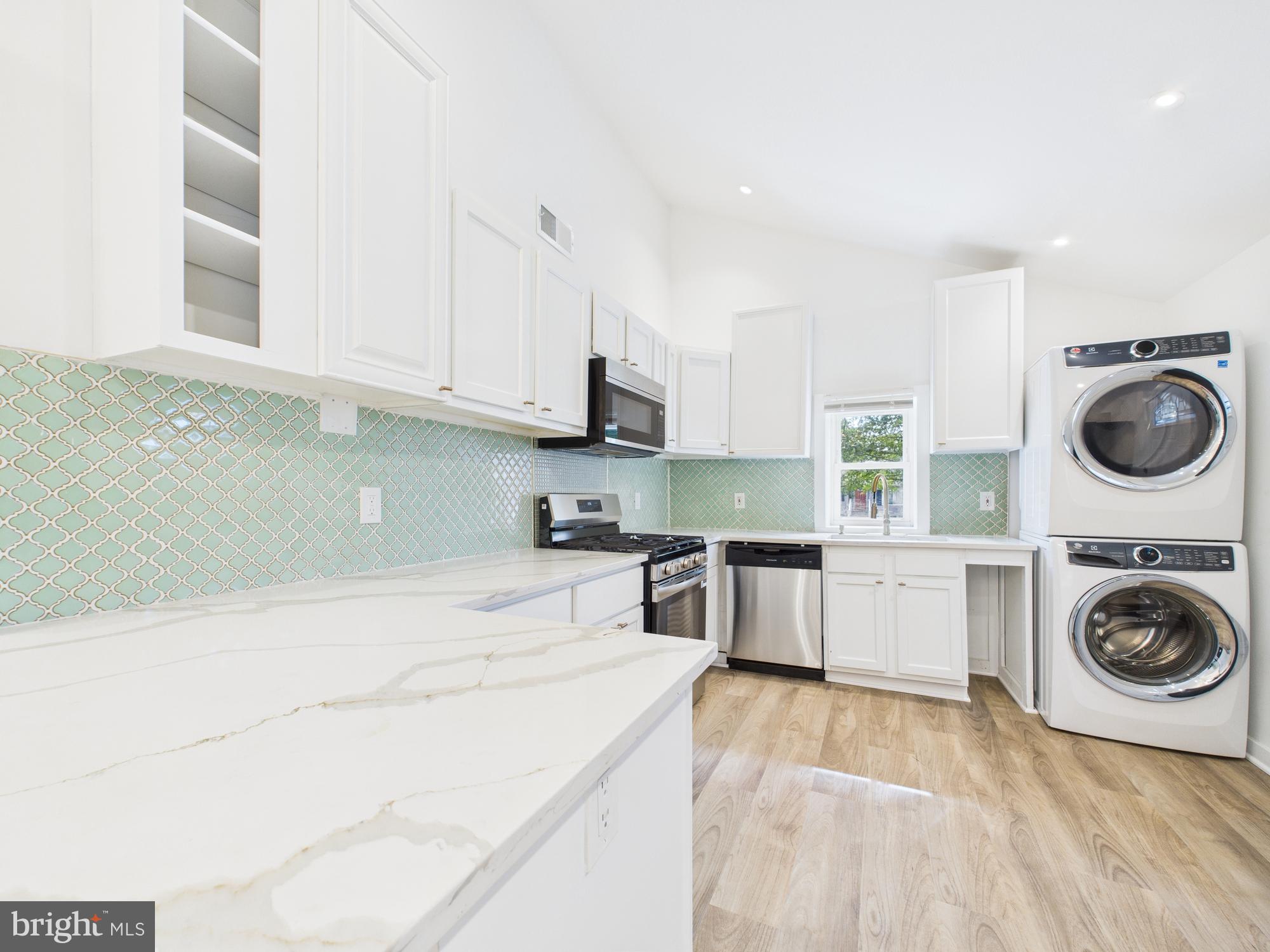 944 Balboa Avenue Capitol Heights, MD 20743 - Photo 14 of 49 a kitchen with a stove top oven sink and cabinets