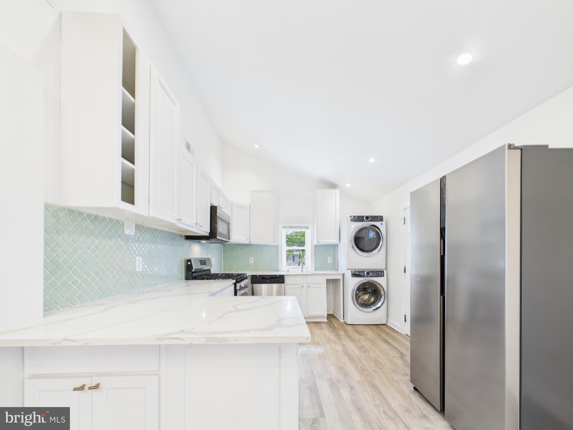 944 Balboa Avenue Capitol Heights, MD 20743 - Photo 17 of 49 a kitchen with stainless steel appliances a refrigerator and a stove top oven
