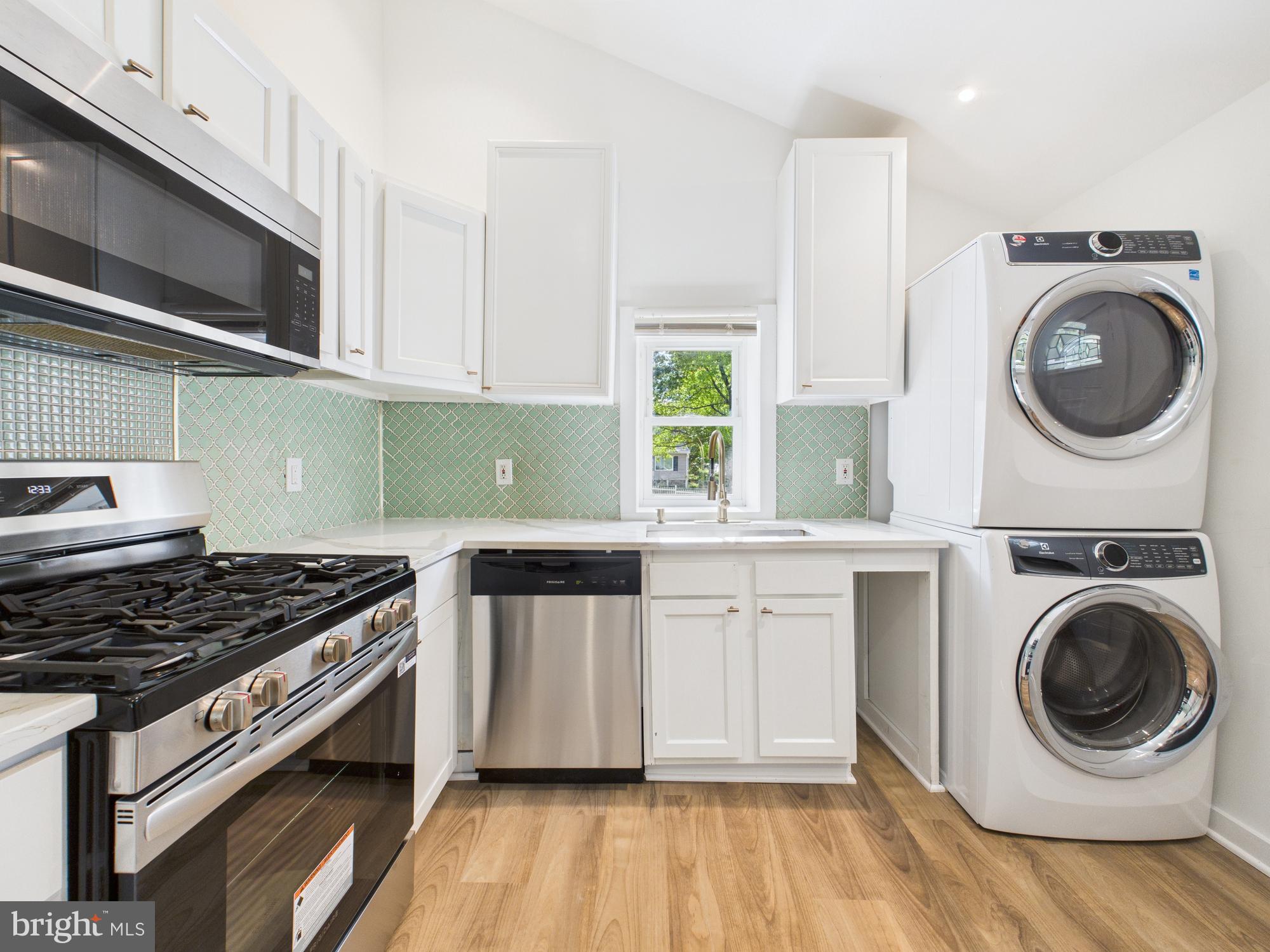 944 Balboa Avenue Capitol Heights, MD 20743 - Photo 2 of 49 a kitchen with granite countertop a sink a stove and cabinets