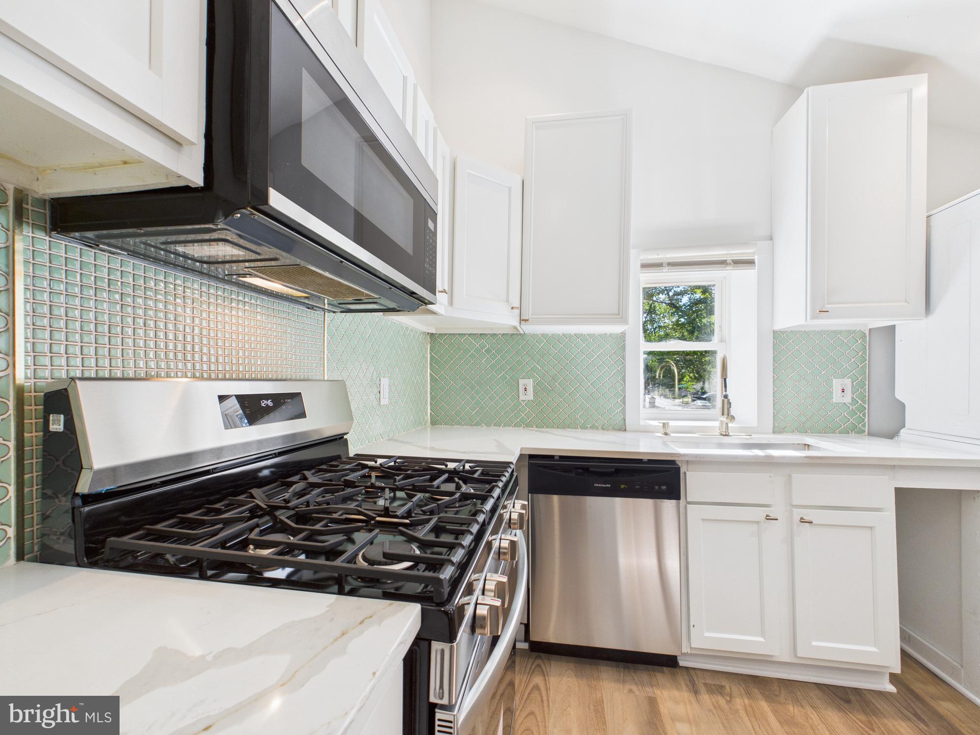 944 Balboa Avenue Capitol Heights, MD 20743 - Photo 10 of 49 a kitchen with wooden cabinets and a stove top oven
