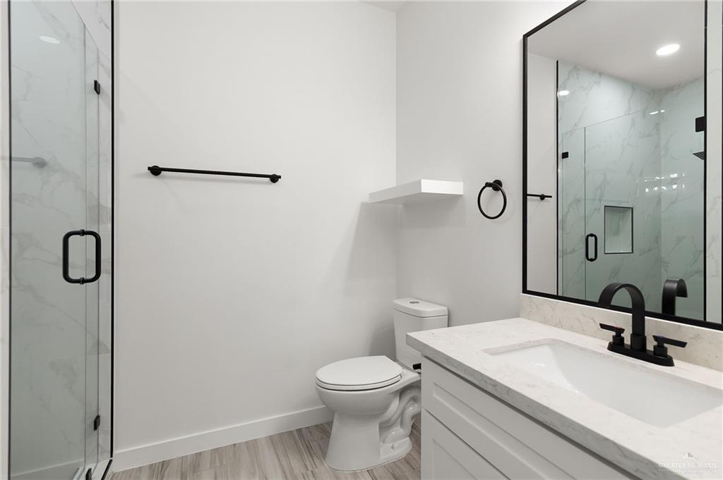 518 East E Loop, Unit 10 Harlingen, TX 78550 - Photo 11 of 14 a bathroom with a sink a toilet and a mirror