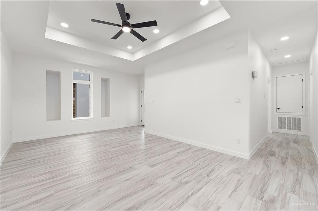 518 East E Loop, Unit 10 Harlingen, TX 78550 - Photo 3 of 14 a view of an empty room with window and wooden floor