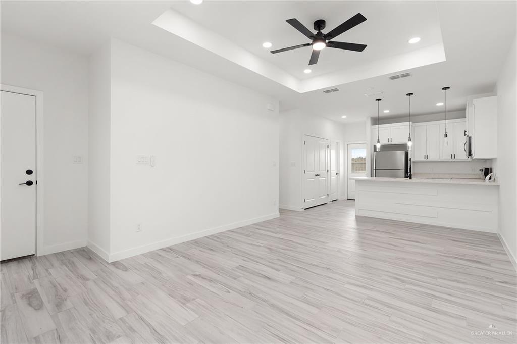 518 East E Loop, Unit 10 Harlingen, TX 78550 - Photo 4 of 14 a view of a kitchen with a stove cabinets and wooden floor