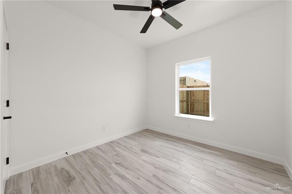 518 East E Loop, Unit 10 Harlingen, TX 78550 - Photo 8 of 14 a view of a room with wooden floor and windows