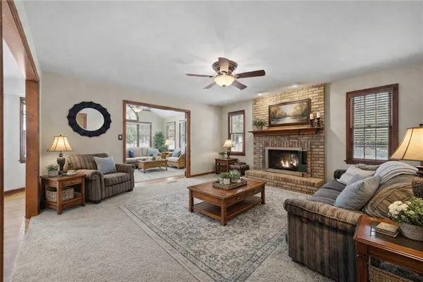 a living room with furniture chandelier and a fireplace