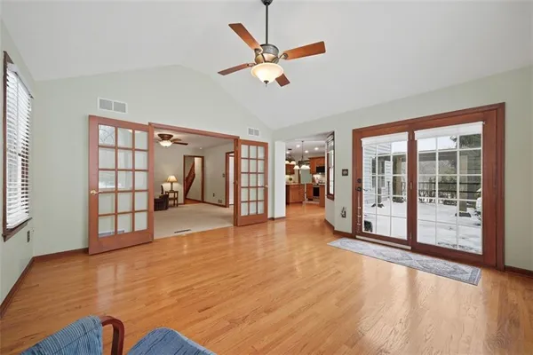 a spacious bedroom with a bed and a chandelier
