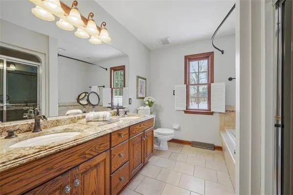 a spacious bedroom with a bed and a window