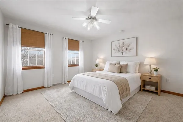 a bathroom with a granite countertop double vanity sink a mirror and a shower
