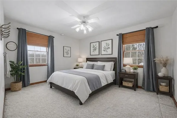 a bedroom with a large bed and a chandelier
