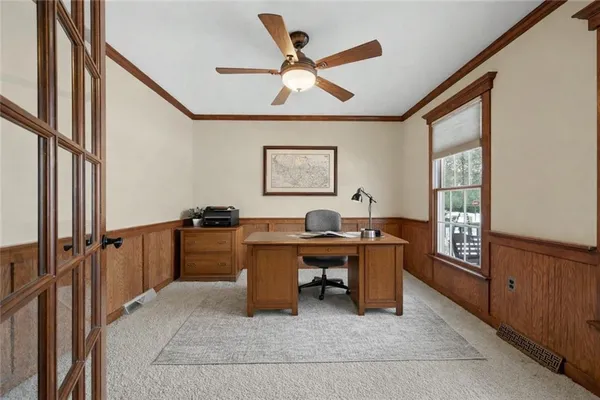 a view of an empty room with window and a ceiling fan