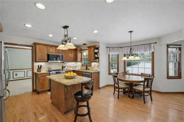a kitchen with stainless steel appliances kitchen island granite countertop a sink and cabinets