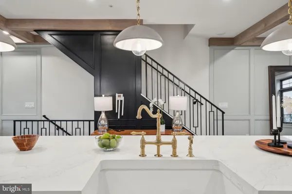 a kitchen with stainless steel appliances a dining table chairs stove and refrigerator