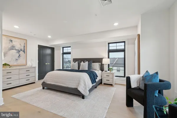 a bedroom with a bed and dresser