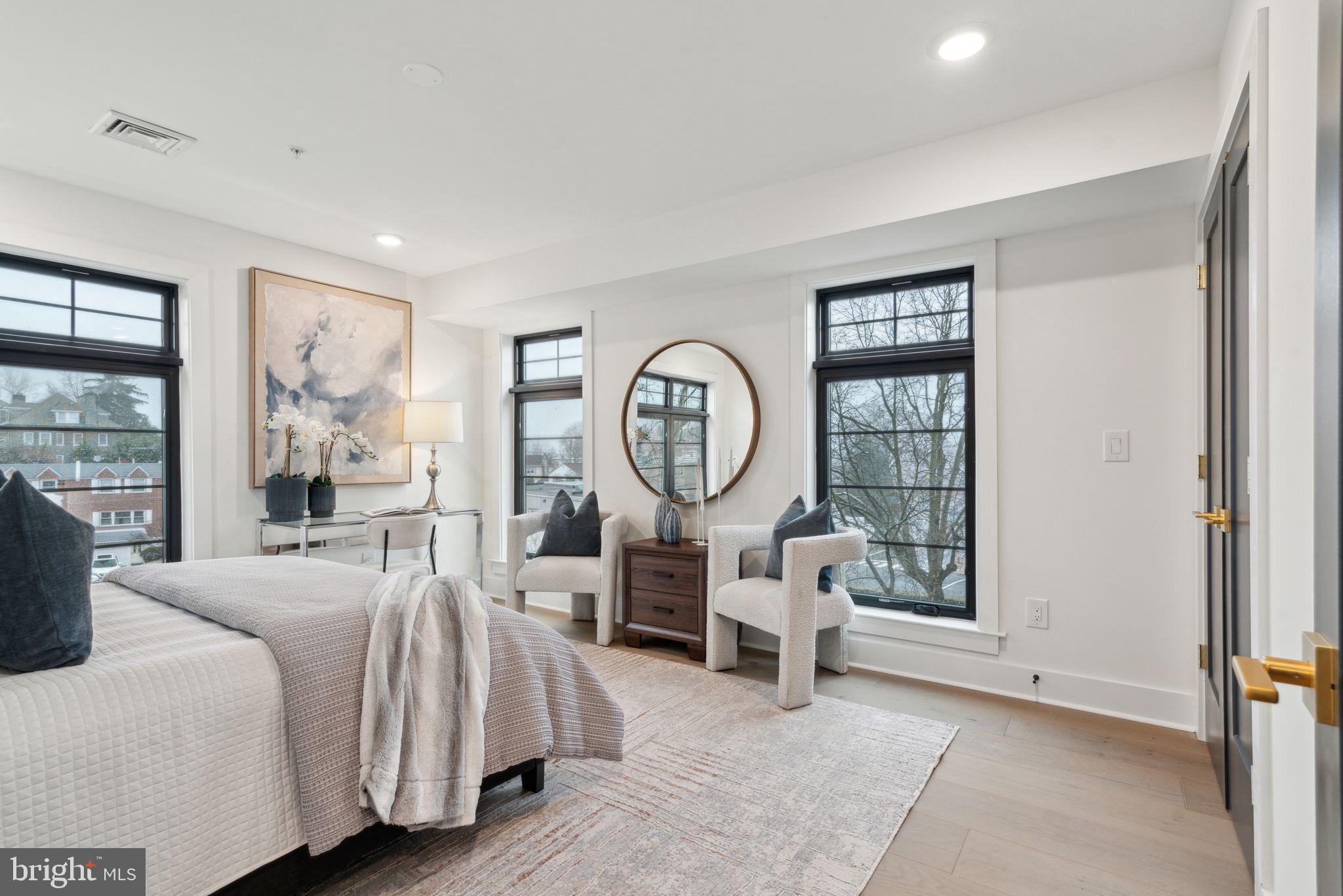 7519 Ridge Avenue, Unit 301 Philadelphia, PA 19128 - Photo 25 of 37 a living room with furniture a large window and a chandelier