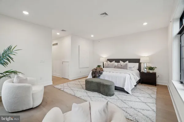 a bedroom with bed and a large window