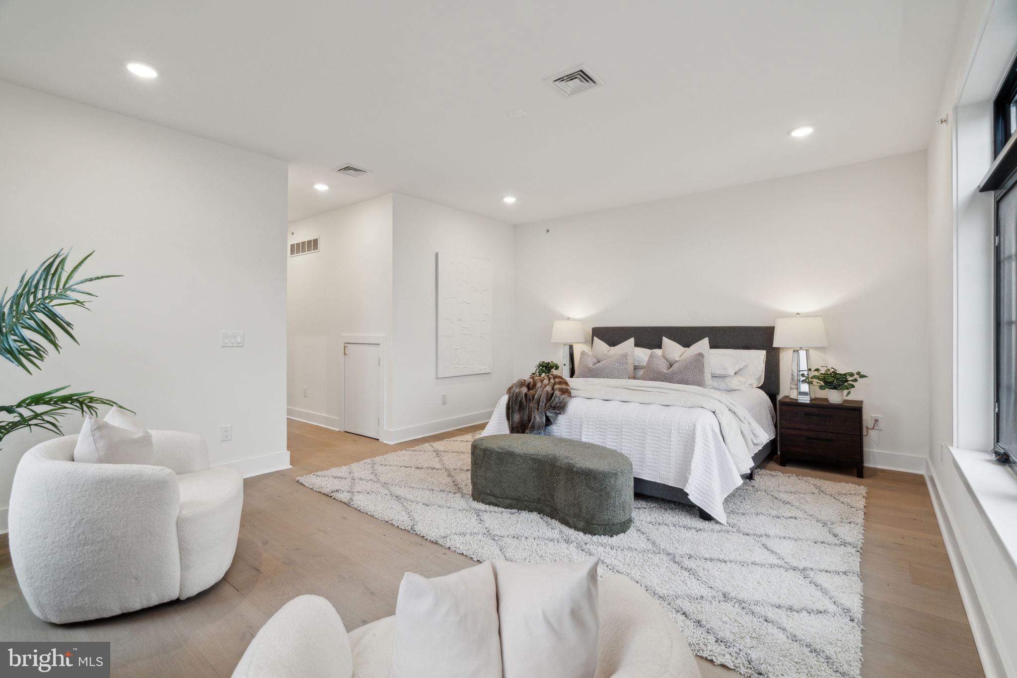 7519 Ridge Avenue, Unit 301 Philadelphia, PA 19128 - Photo 34 of 37 a bedroom with a large bed and a couch