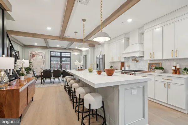 a kitchen with a table chairs stove and cabinets