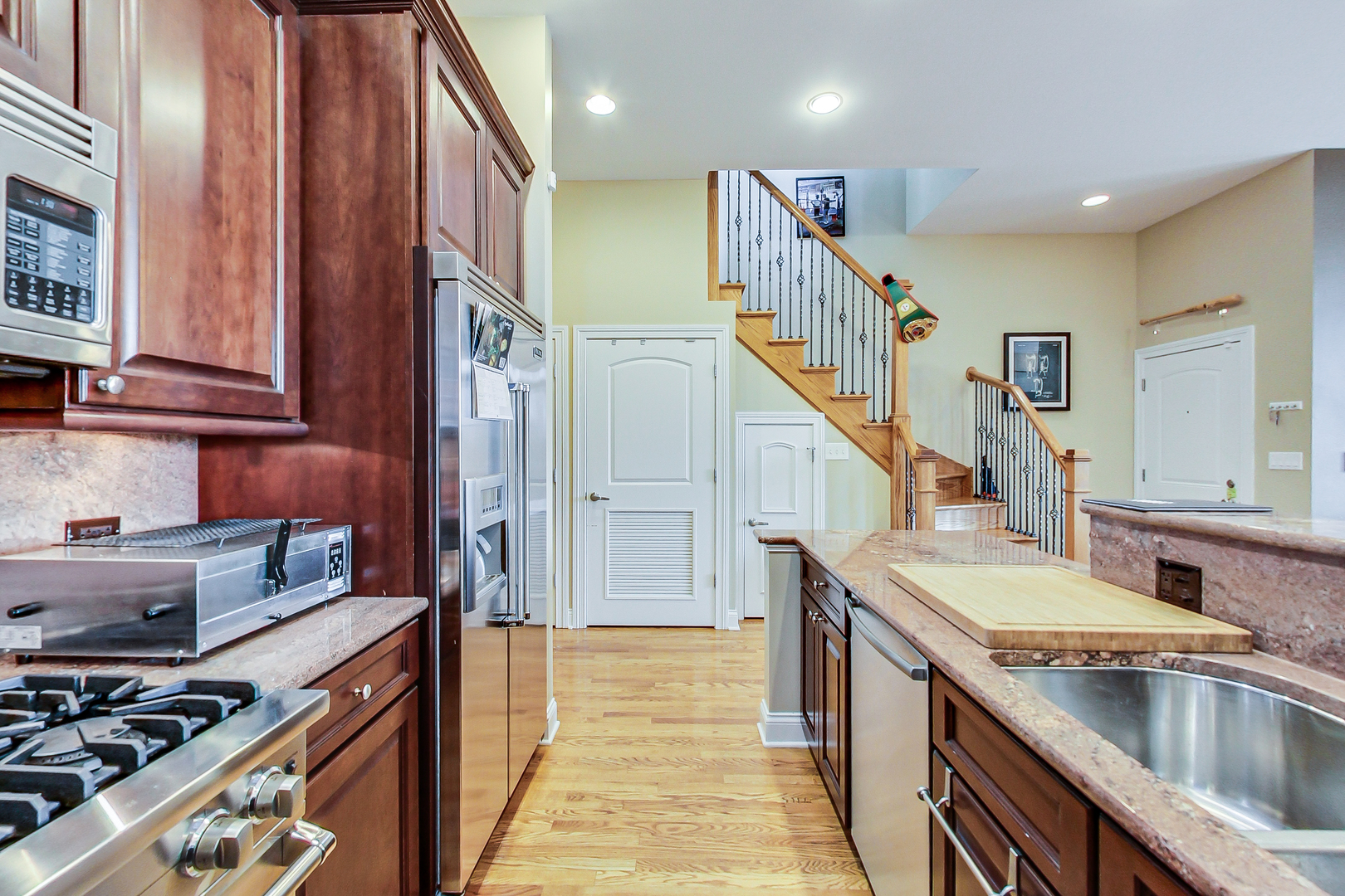 1116 West Hubbard Street, Unit 4W Chicago, IL 60642 - Photo 12 of 32 a kitchen with sink a stove and cabinets