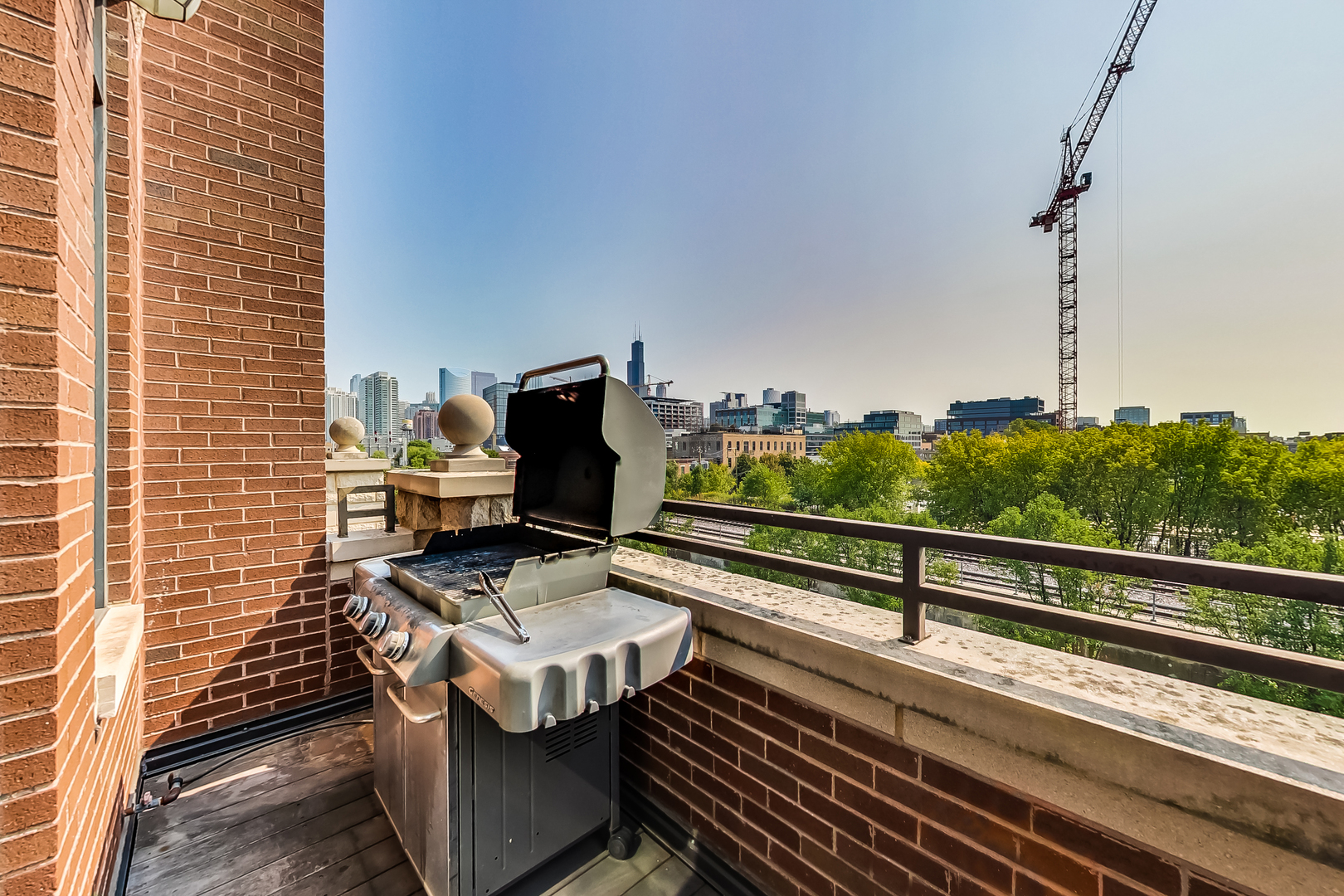 1116 West Hubbard Street, Unit 4W Chicago, IL 60642 - Photo 8 of 32 a view of a balcony with wooden floor and outdoor seating