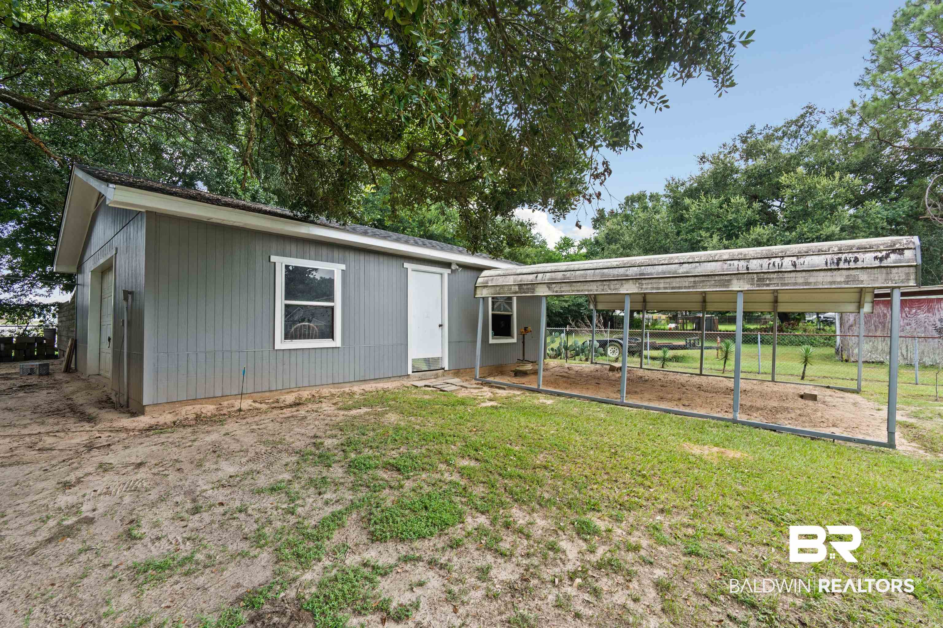 2000 Campfire Drive Semmes, AL 36575 - Photo 26 of 26 Rear view of house with a carport and a lawn