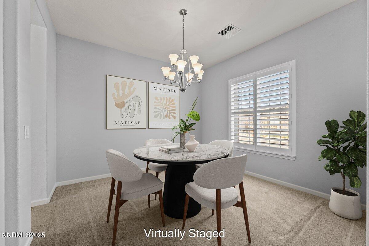 2250 Trakehner Lane Reno, NV 89521 - Photo 13 of 51 a view of a dining room with furniture and a chandelier