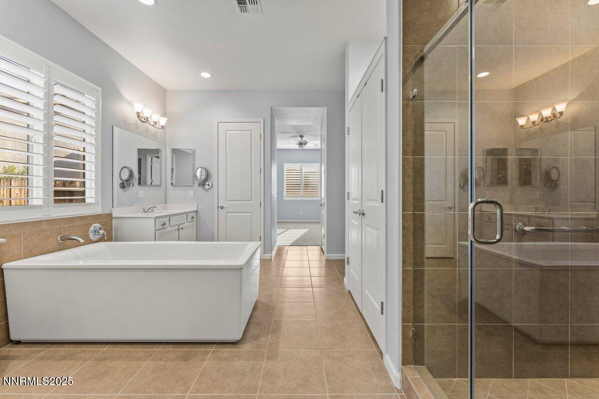 2250 Trakehner Lane Reno, NV 89521 - Photo 22 of 51 a view of a bathroom with a tub sink shower and mirror