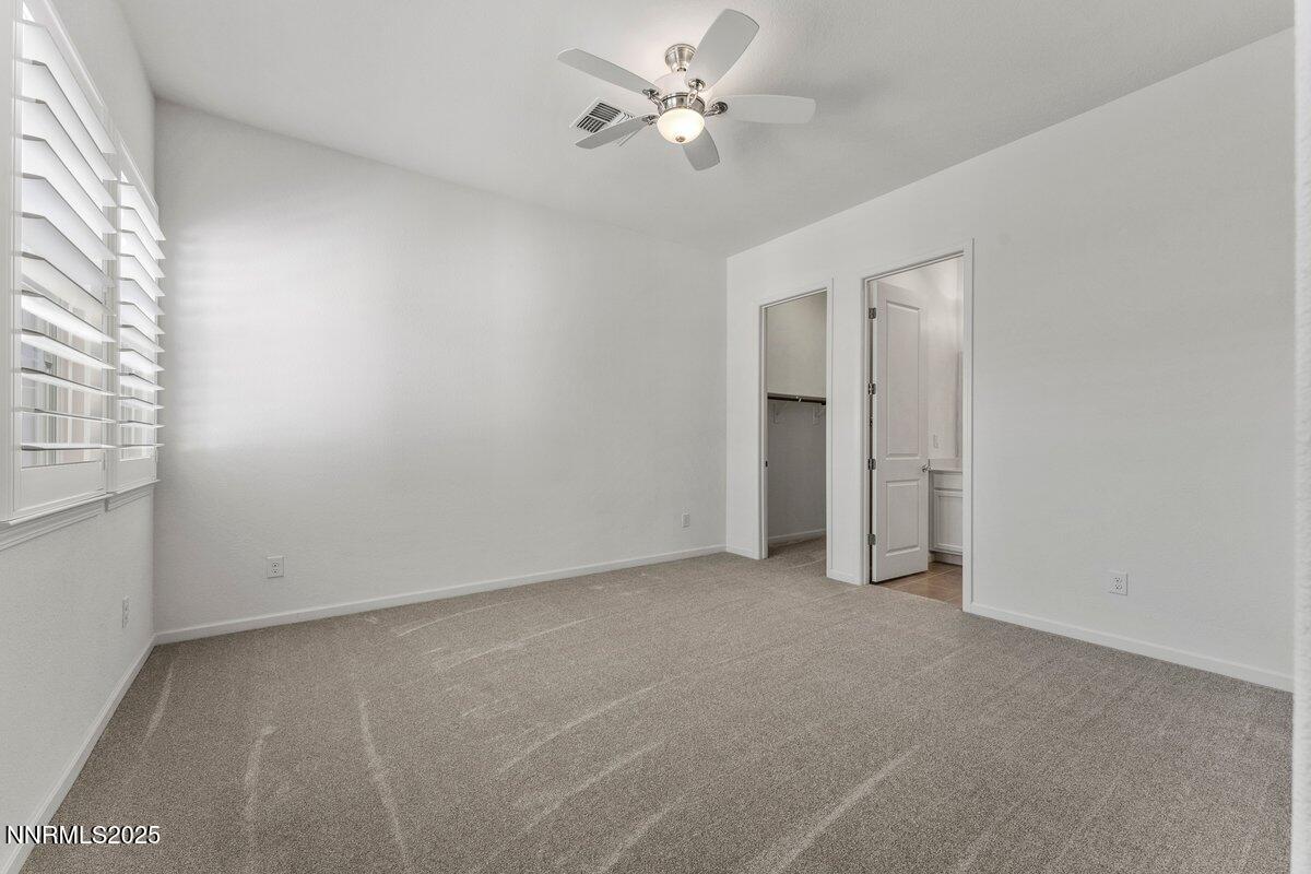 2250 Trakehner Lane Reno, NV 89521 - Photo 24 of 51 an empty room with a ceiling fan and a window