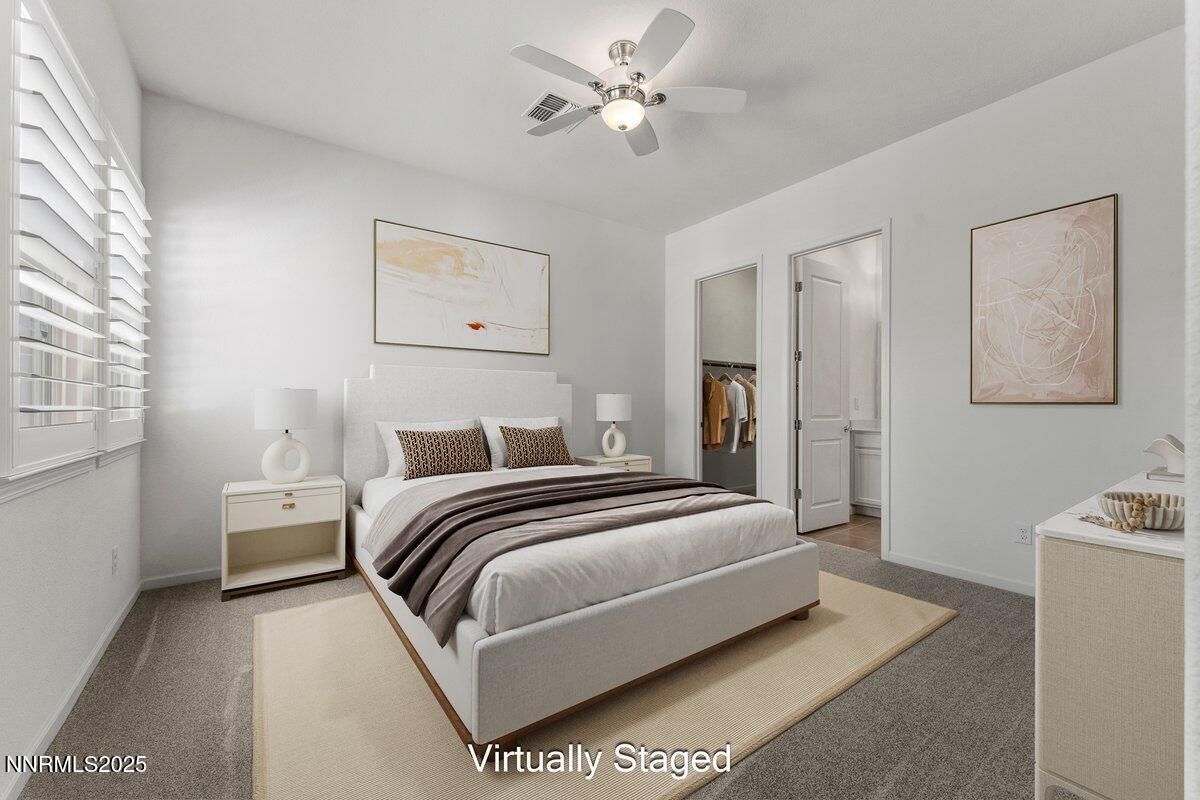 2250 Trakehner Lane Reno, NV 89521 - Photo 25 of 51 a bedroom with a bed and a chandelier