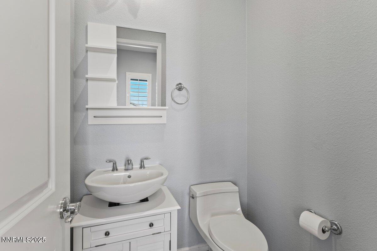 2250 Trakehner Lane Reno, NV 89521 - Photo 27 of 51 a bathroom with a toilet sink and mirror