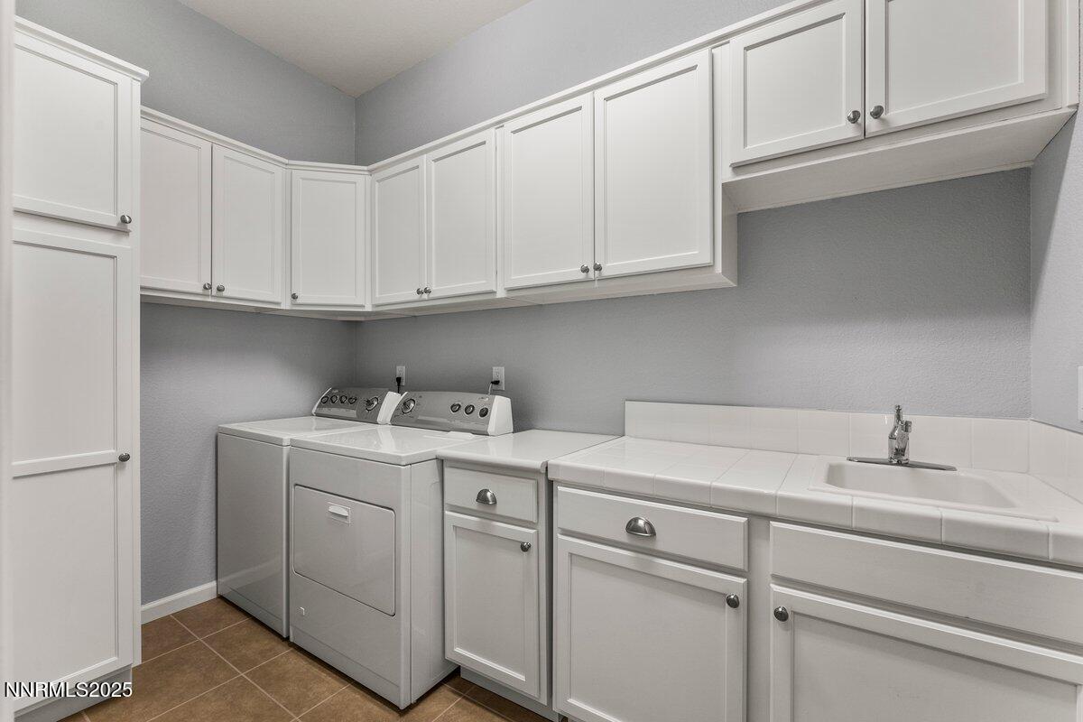 2250 Trakehner Lane Reno, NV 89521 - Photo 29 of 51 a view of cabinets with washer and dryer