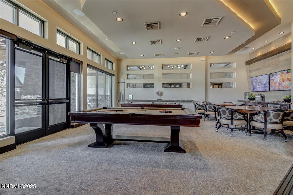 2250 Trakehner Lane Reno, NV 89521 - Photo 46 of 51 a living room with furniture a table and a projector screen