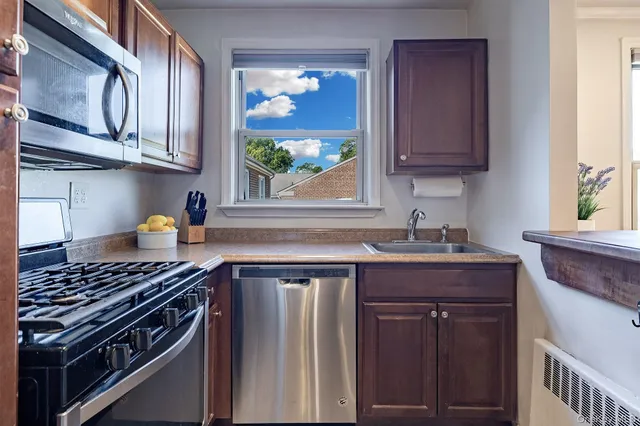 a kitchen with stainless steel appliances granite countertop a stove and a sink