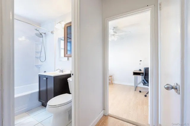 a bathroom with a granite countertop sink toilet and shower